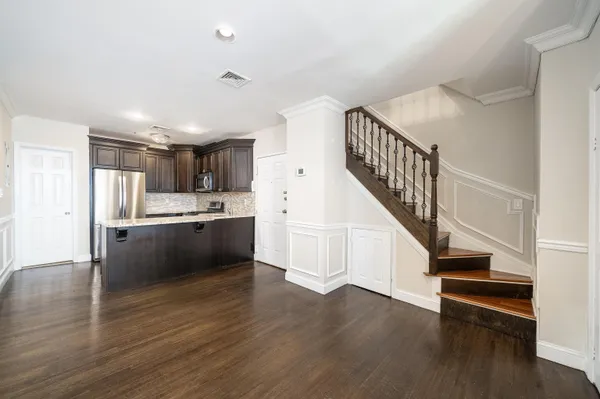 a view of kitchen with wooden floor and electronic appliances
