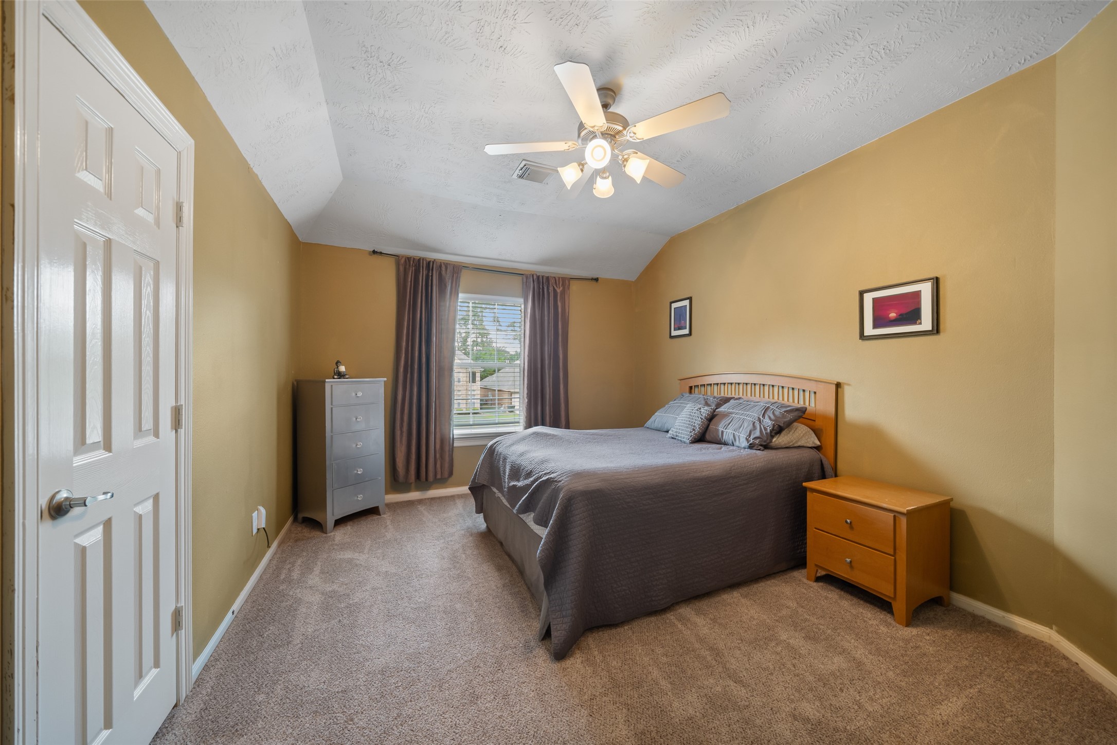 6407 Ashley Manor Drive Spring, TX 77389 - Photo 31 of 41 a bedroom with a bed and a chandelier