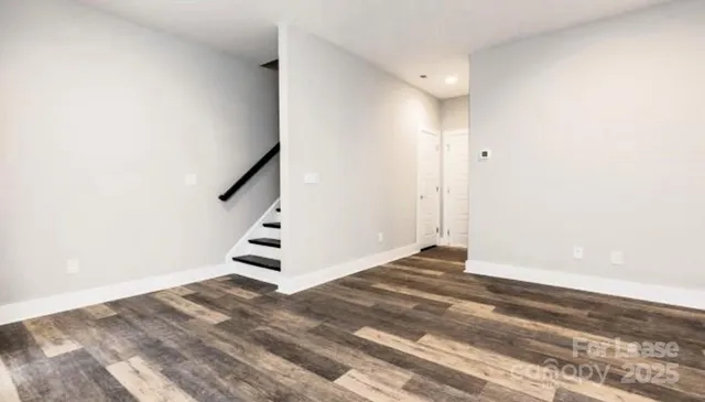 a view of an empty room with stairs and ventilation
