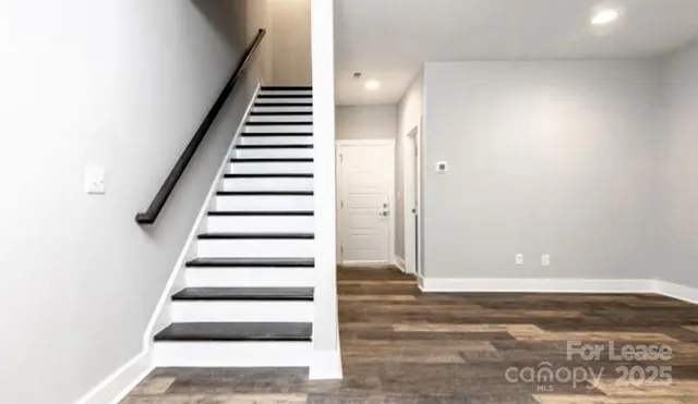 a view of entryway and hall with wooden floor