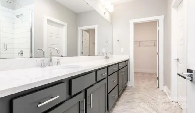 a bathroom with a double vanity sink and a mirror