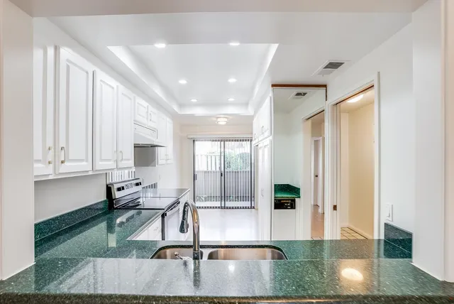 an empty room with wooden floor and door