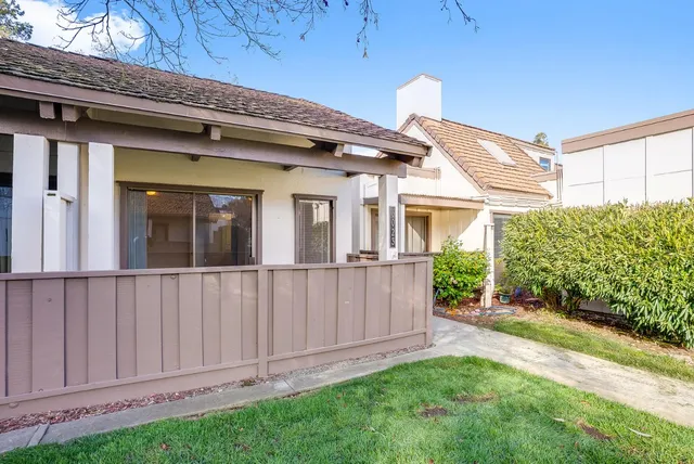 a view of a house with porch and garden