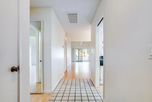 a view of livingroom with hallway and chandelier