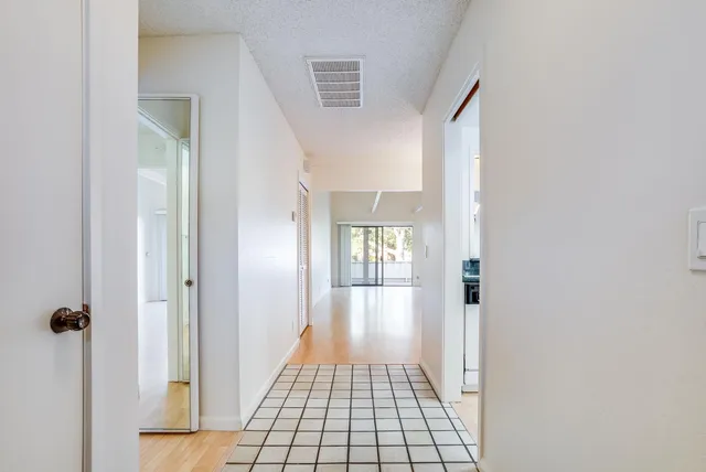 a view of livingroom with hallway and chandelier