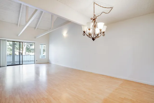 a view of a chandelier fan and wooden floor