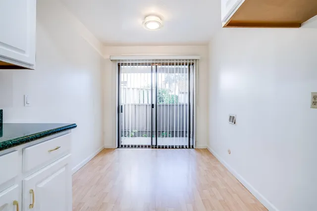 a kitchen with granite countertop white cabinets and a stove