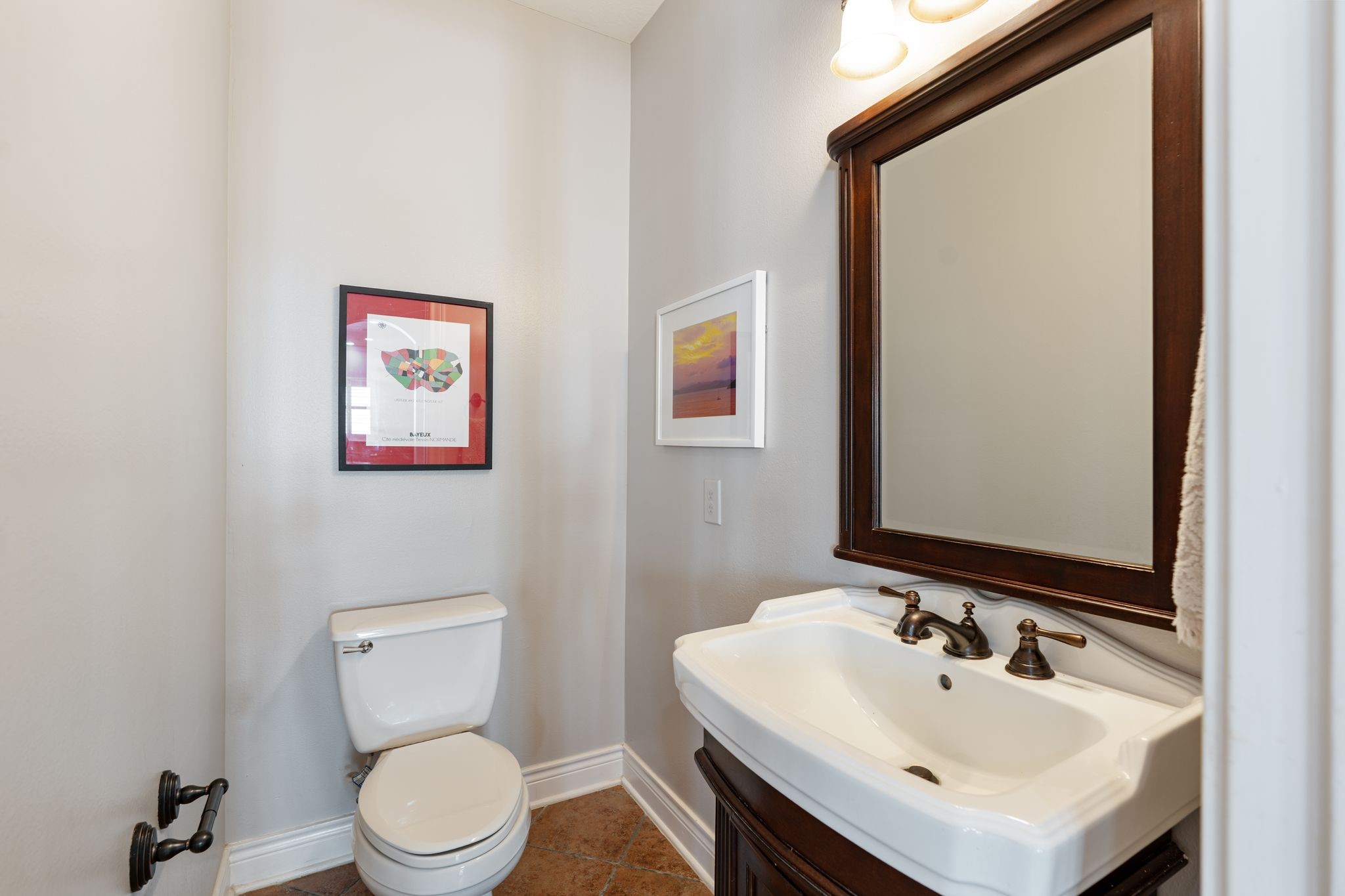 3822 Merrick Street Houston, TX 77025 - Photo 14 of 34 A conveniently located powder bath on the main floor features a dark wood vanity with a vessel-style sink, oil-rubbed bronze fixtures, a wood-framed mirror, and tile flooring.