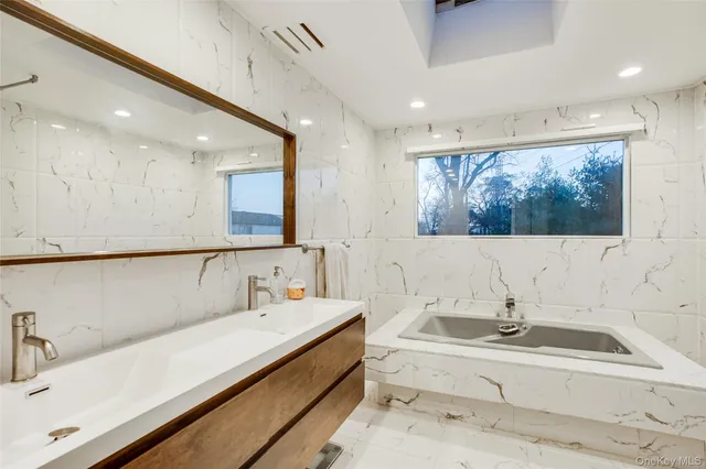 a bathroom with a bathtub and a sink