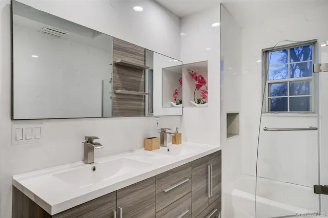 a bathroom with a sink vanity and mirror