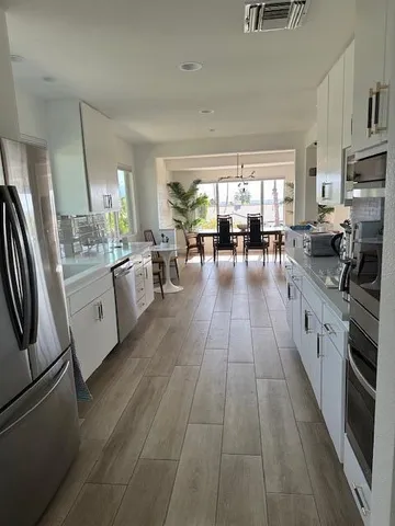 a view of a dining room with furniture and wooden floor