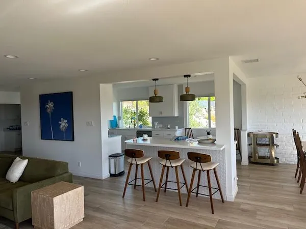 a view of a dining room with furniture wooden floor and a chandelier