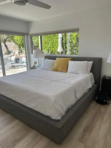 a bedroom with a bed and a chandelier