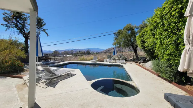 a backyard of a house with table and chairs
