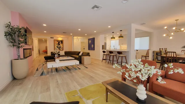 a living room with furniture and a floor to ceiling window