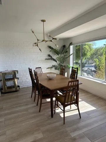 a living room with fireplace furniture and floor to ceiling windows