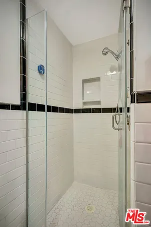a bathroom with a shower and a glass door