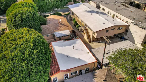 an aerial view of residential houses with outdoor space