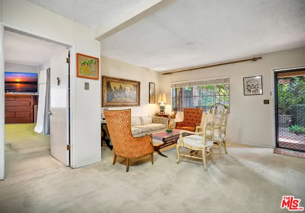a living room with furniture and a floor to ceiling window