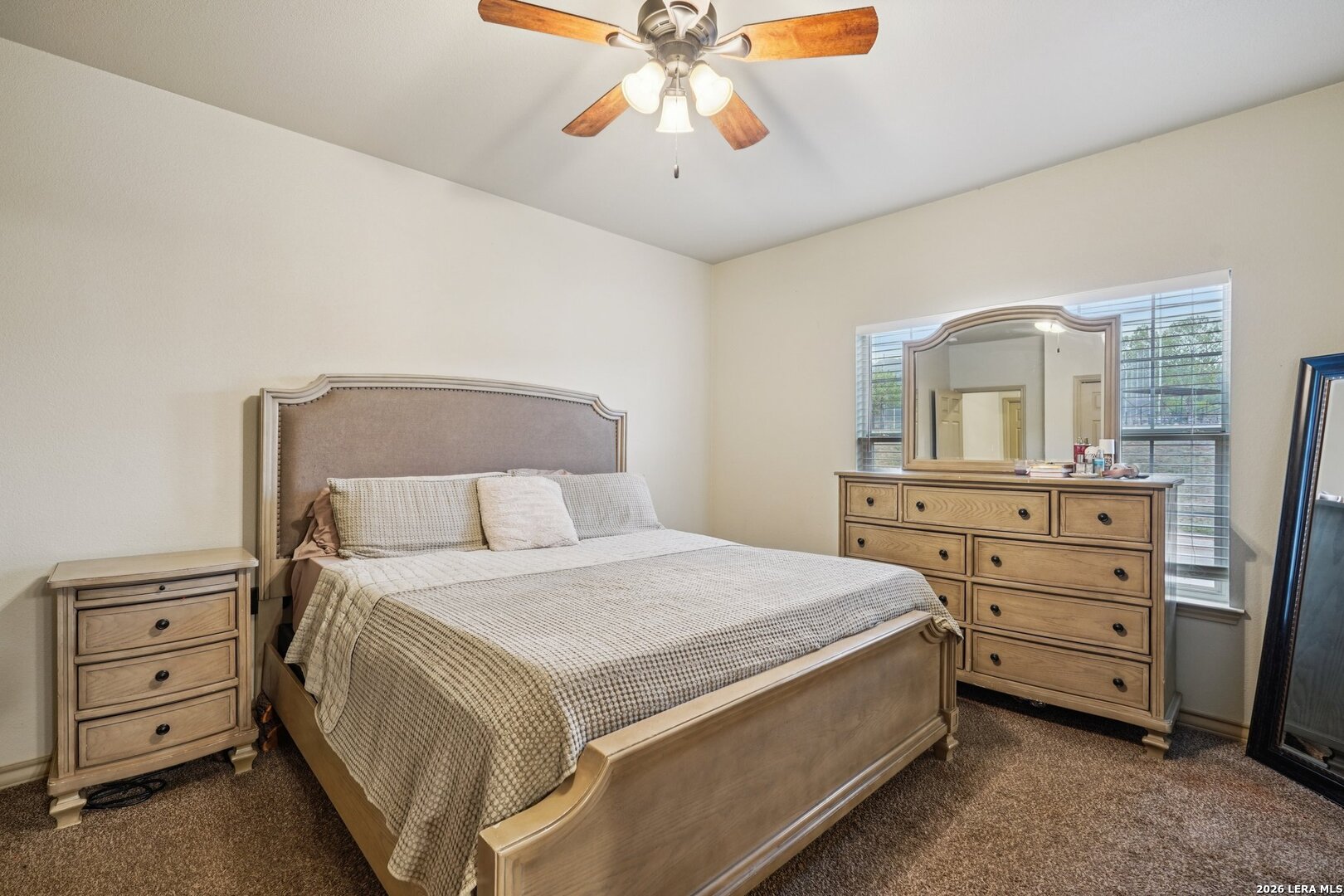 2312 Sailing Way, Unit D Kerrville, TX 78028 - Photo 13 of 25 a bedroom with a bed and a dresser