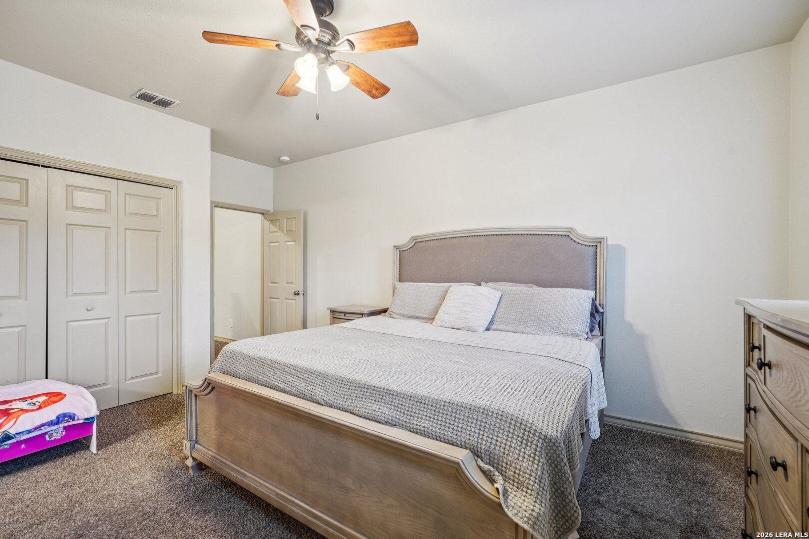 2312 Sailing Way, Unit D Kerrville, TX 78028 - Photo 14 of 25 a bedroom with a bed and a chandelier