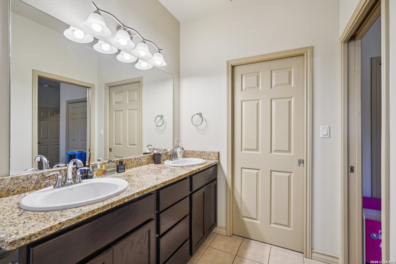 2312 Sailing Way, Unit D Kerrville, TX 78028 - Photo 16 of 25 a bathroom with a granite countertop sink a light fixture and a mirror