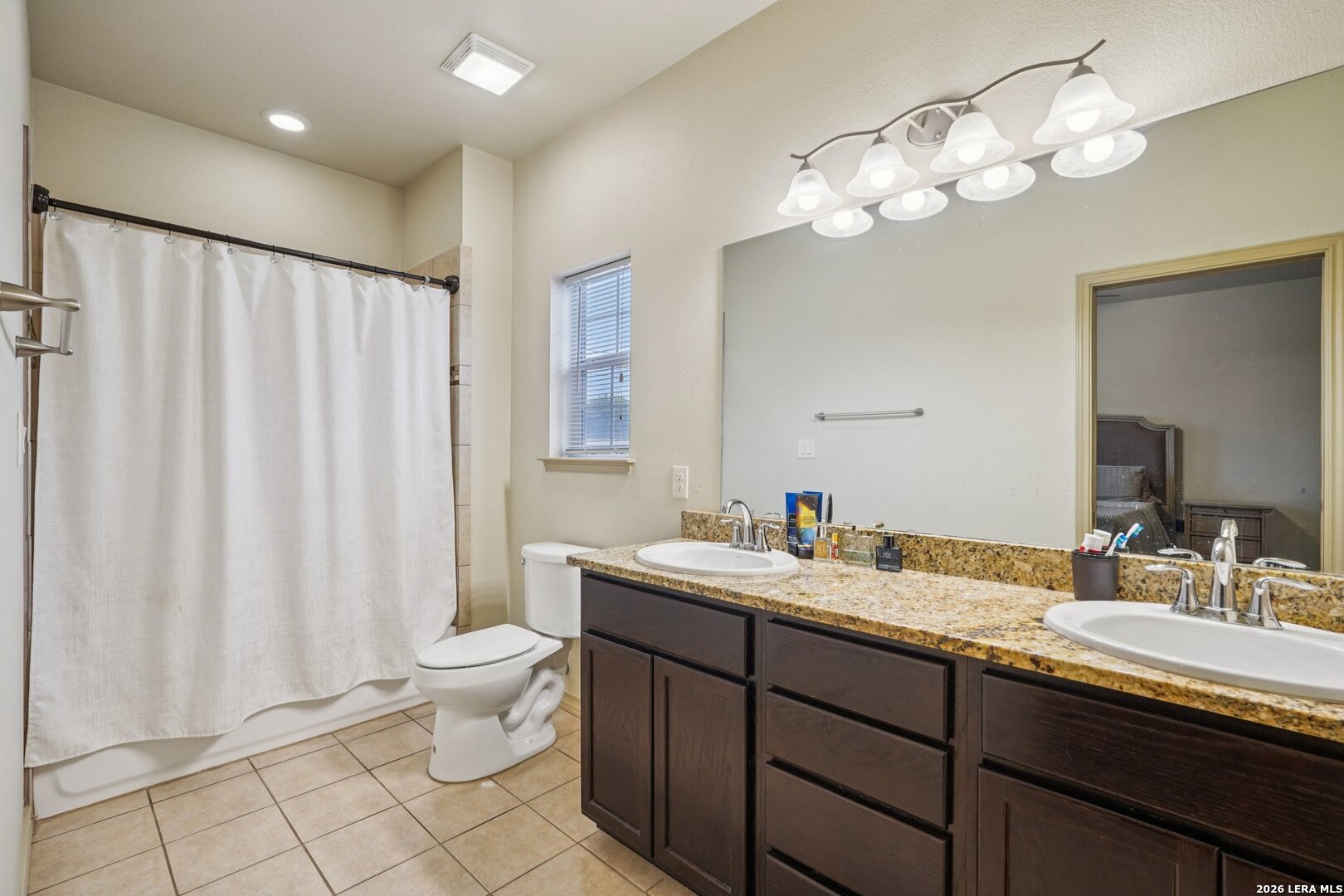 2312 Sailing Way, Unit D Kerrville, TX 78028 - Photo 17 of 25 a bathroom with a double vanity sink mirror and toilet