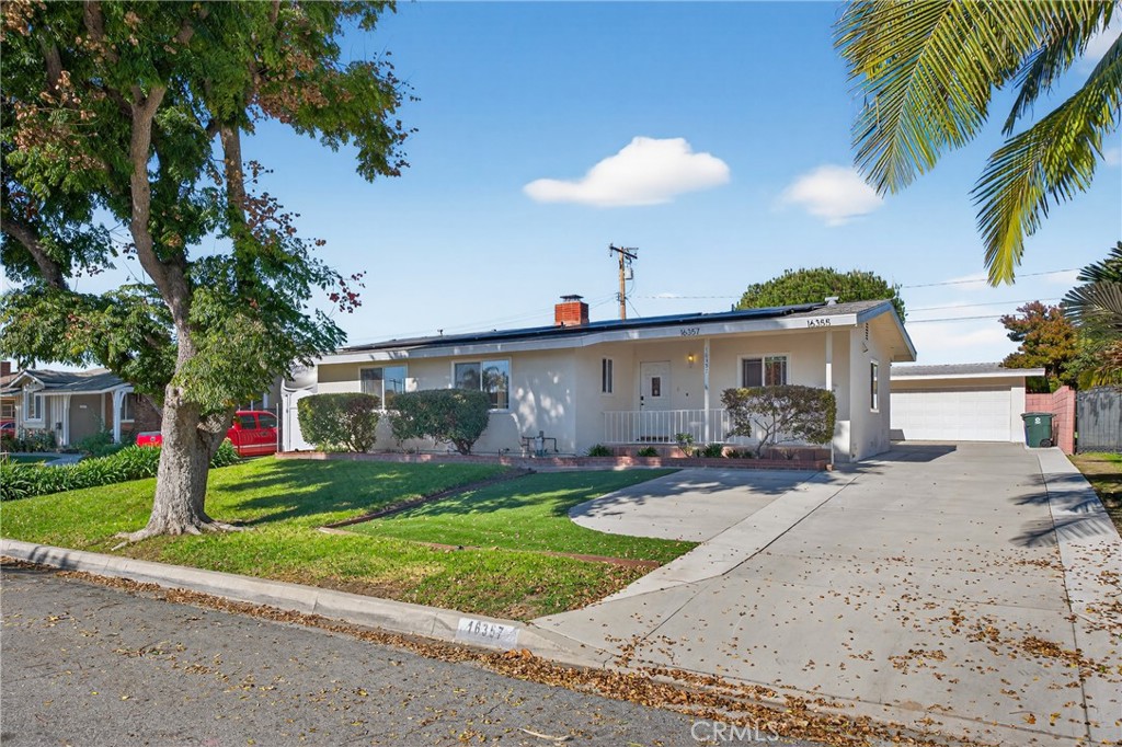 16357 Lisco Street Whittier, CA 90603 - Photo 1 of 1 a front view of a house with a yard and garage