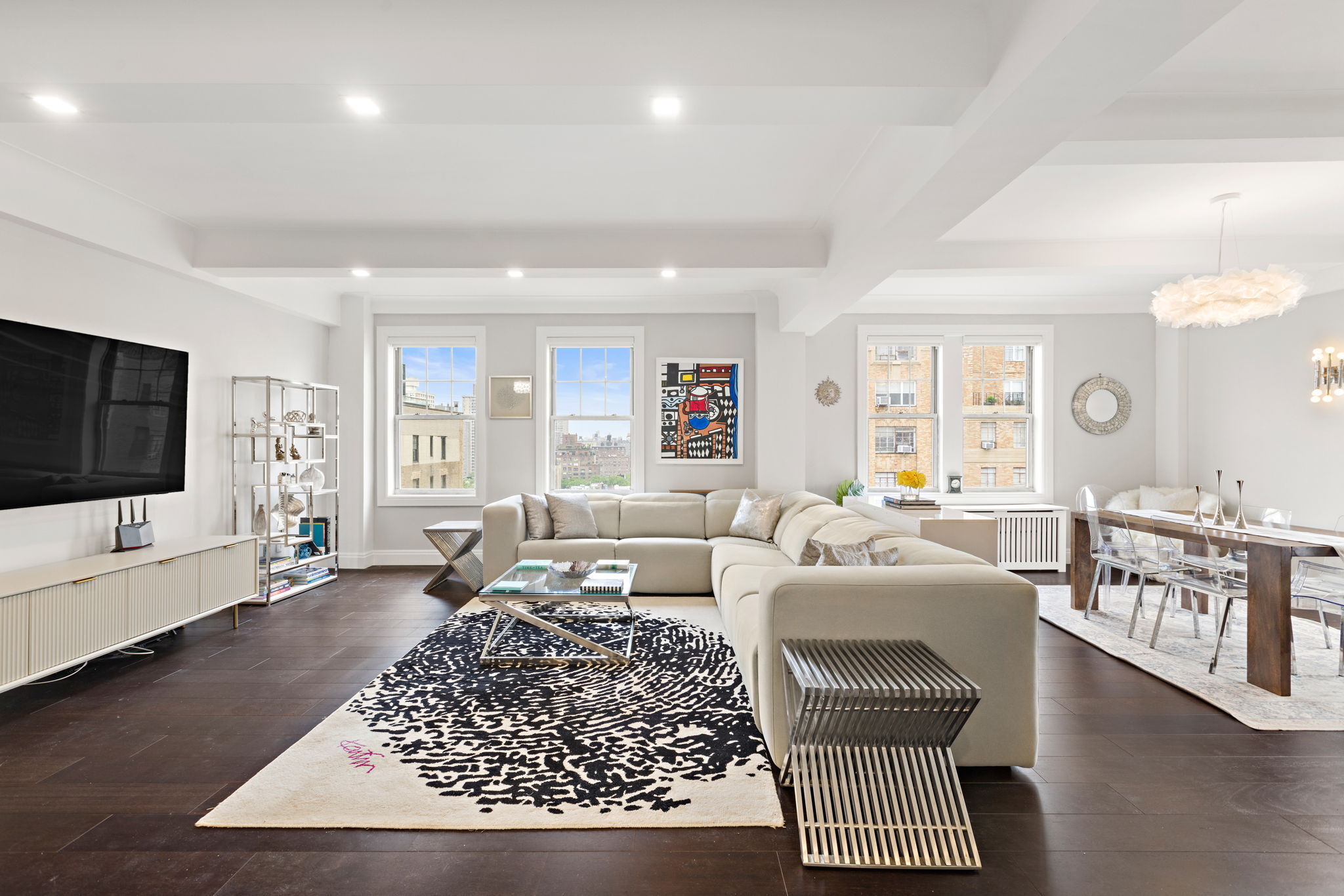 10 West 86th Street, Unit PH15A Manhattan, NY 10024 - Photo 2 of 34 a living room with furniture or couch and a flat screen tv