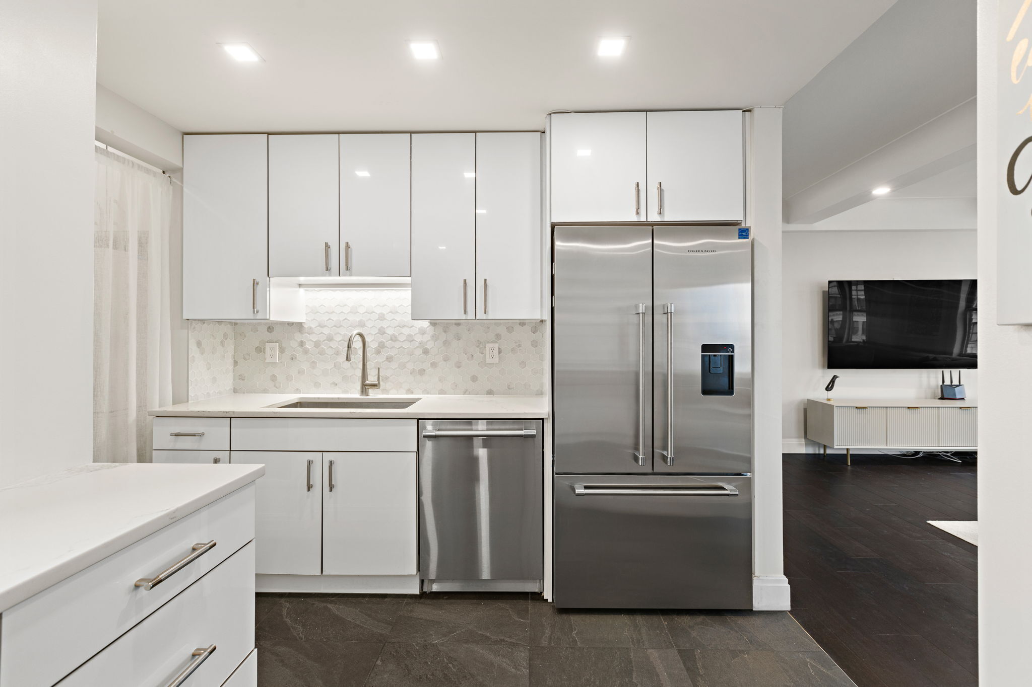 10 West 86th Street, Unit PH15A Manhattan, NY 10024 - Photo 20 of 34 a kitchen with kitchen island white cabinets and stainless steel appliances