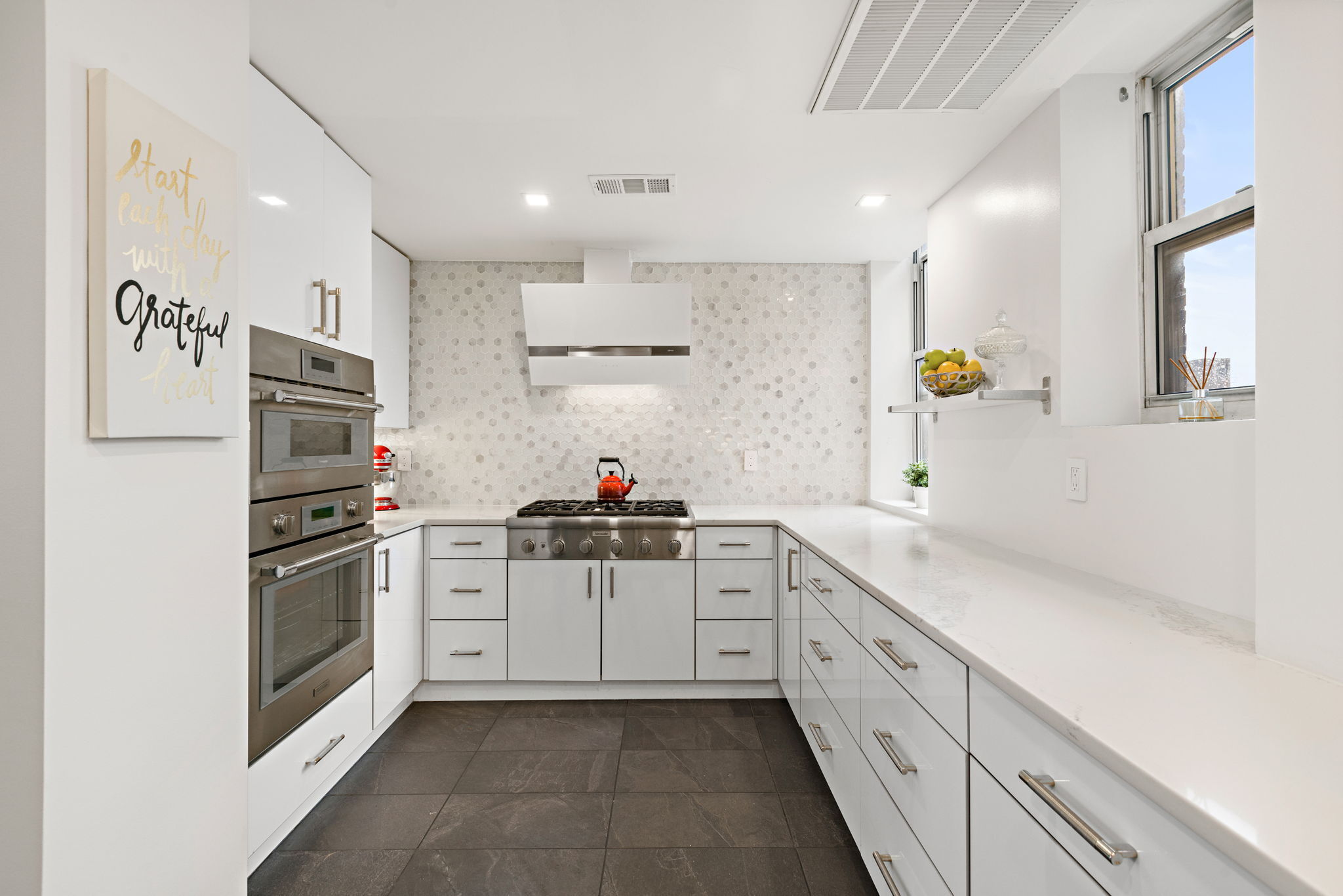 10 West 86th Street, Unit PH15A Manhattan, NY 10024 - Photo 21 of 34 a kitchen with granite countertop a sink stainless steel appliances and cabinets