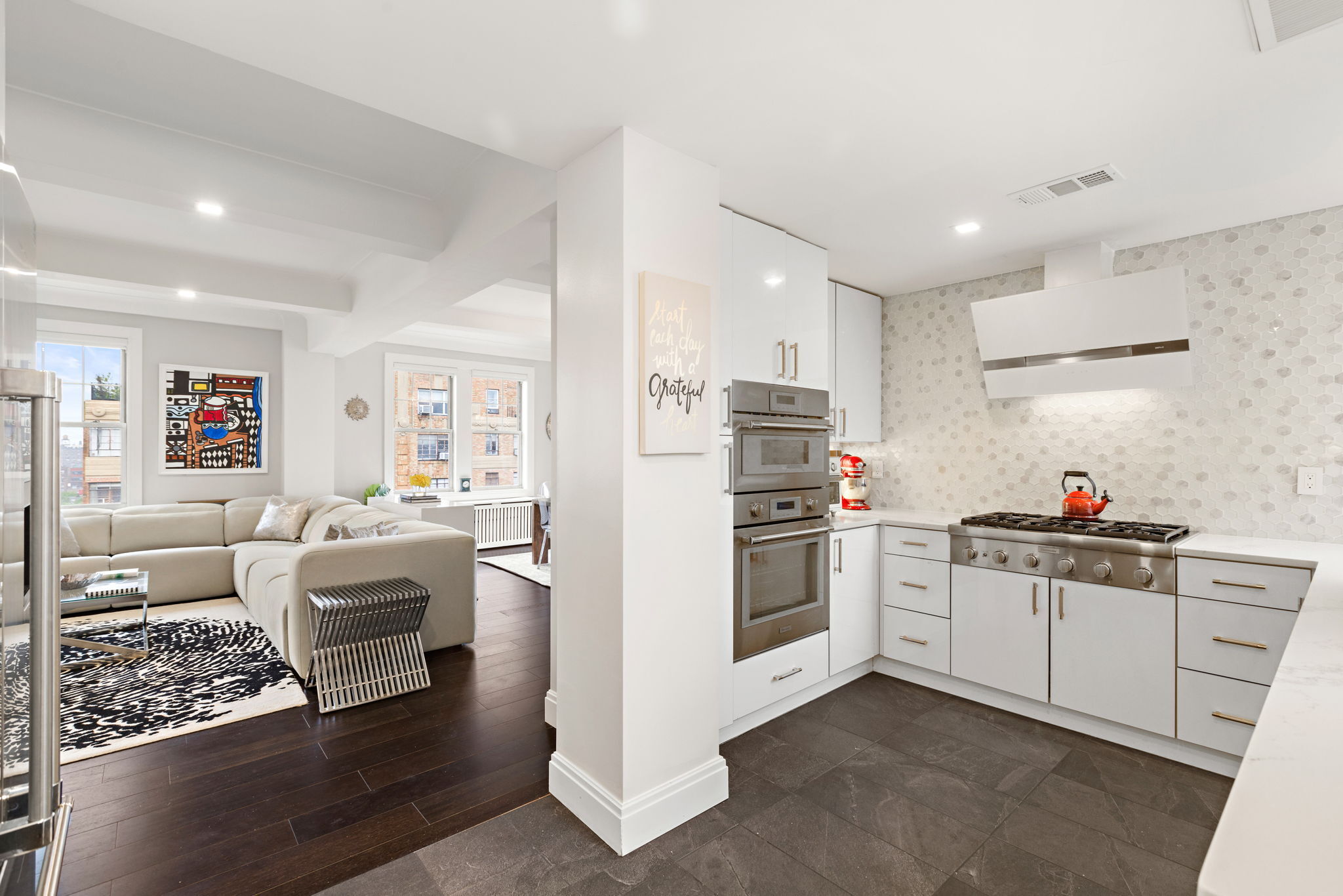 10 West 86th Street, Unit PH15A Manhattan, NY 10024 - Photo 3 of 34 a kitchen with white cabinets and white appliances