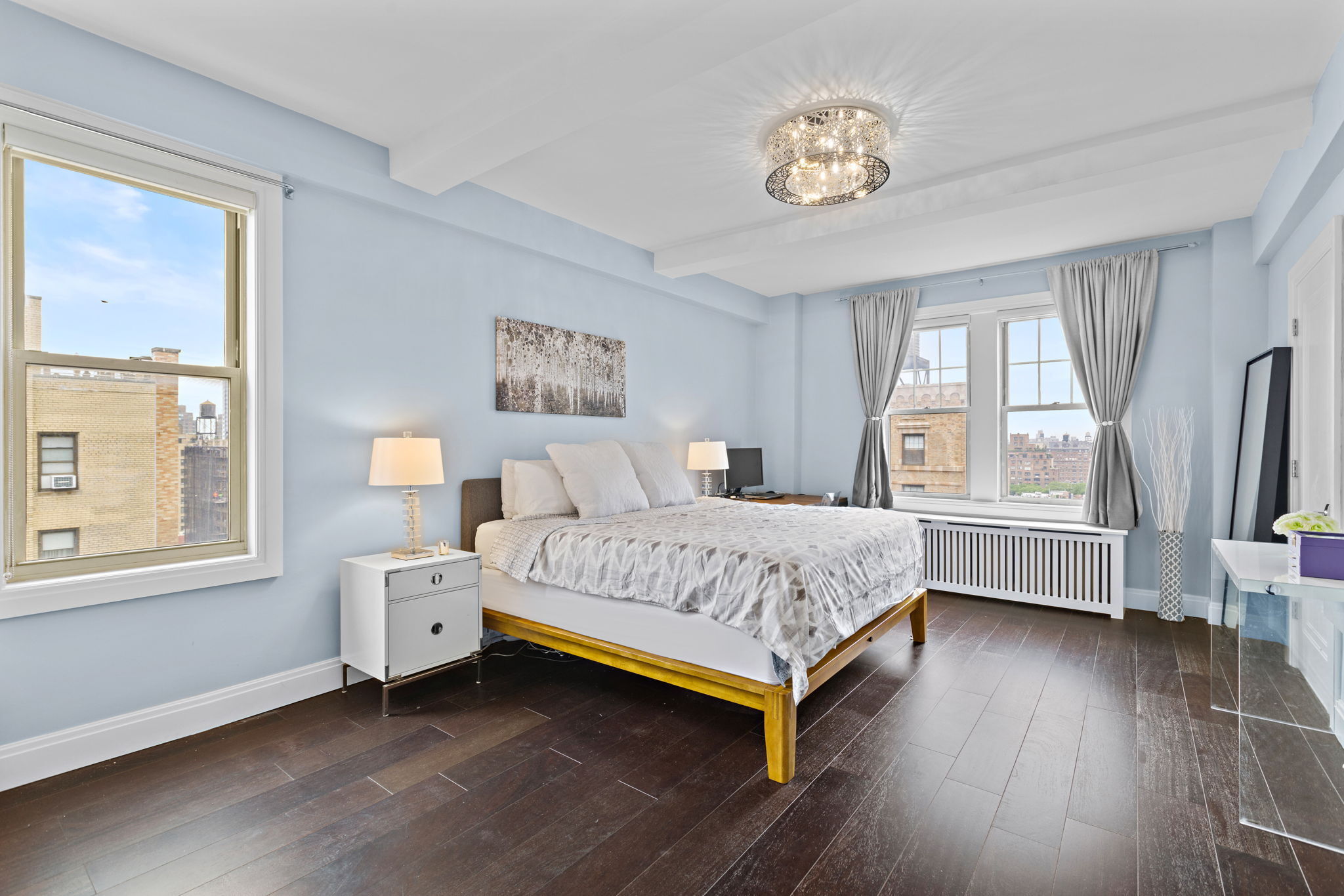 10 West 86th Street, Unit PH15A Manhattan, NY 10024 - Photo 7 of 34 a bedroom with a bed and a large window with wooden floor