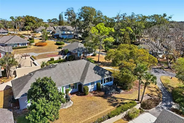 an aerial view of a house with a yard and lake view