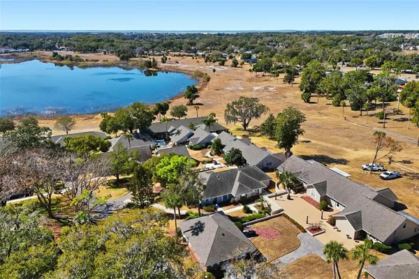an aerial view of ocean and residential houses with outdoor space