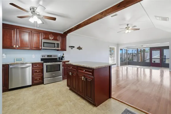 a kitchen with stainless steel appliances granite countertop a stove cabinets and refrigerator