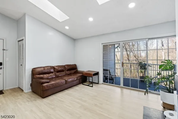 a living room with furniture and a floor to ceiling window