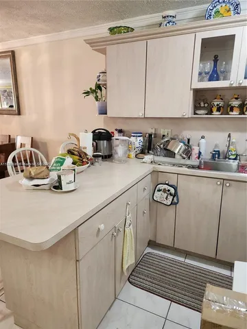 a kitchen with a sink cabinets and appliances