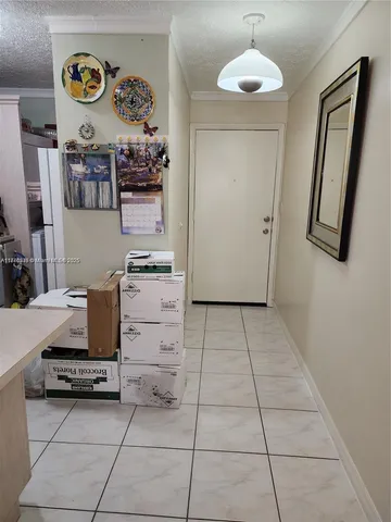 a kitchen with a refrigerator and cabinets