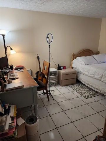 a bedroom with furniture and a gym equipment