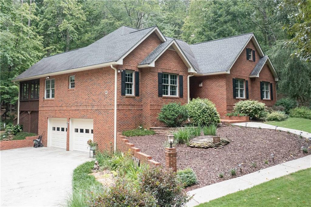 5885 West Chapel Hill Road Douglasville, GA 30135 - Photo 1 of 42 a view of a yard in front of a house with plants and large tree