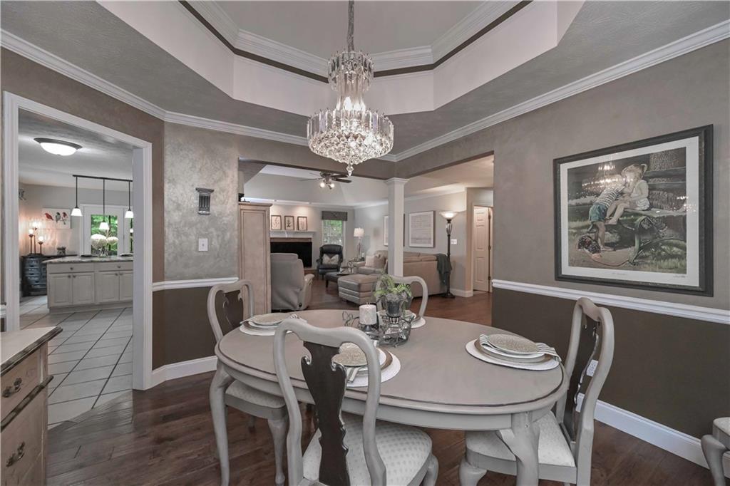 5885 West Chapel Hill Road Douglasville, GA 30135 - Photo 11 of 42 a view of a dining room with furniture a chandelier and wooden floor