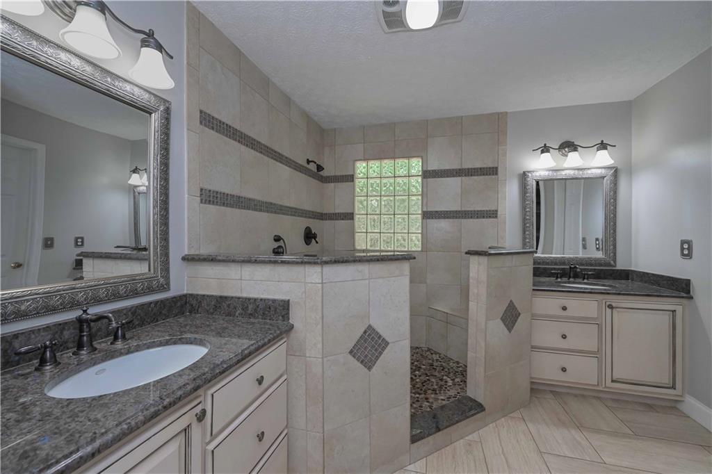 5885 West Chapel Hill Road Douglasville, GA 30135 - Photo 26 of 42 a bathroom with a granite countertop sink double vanity and a mirror