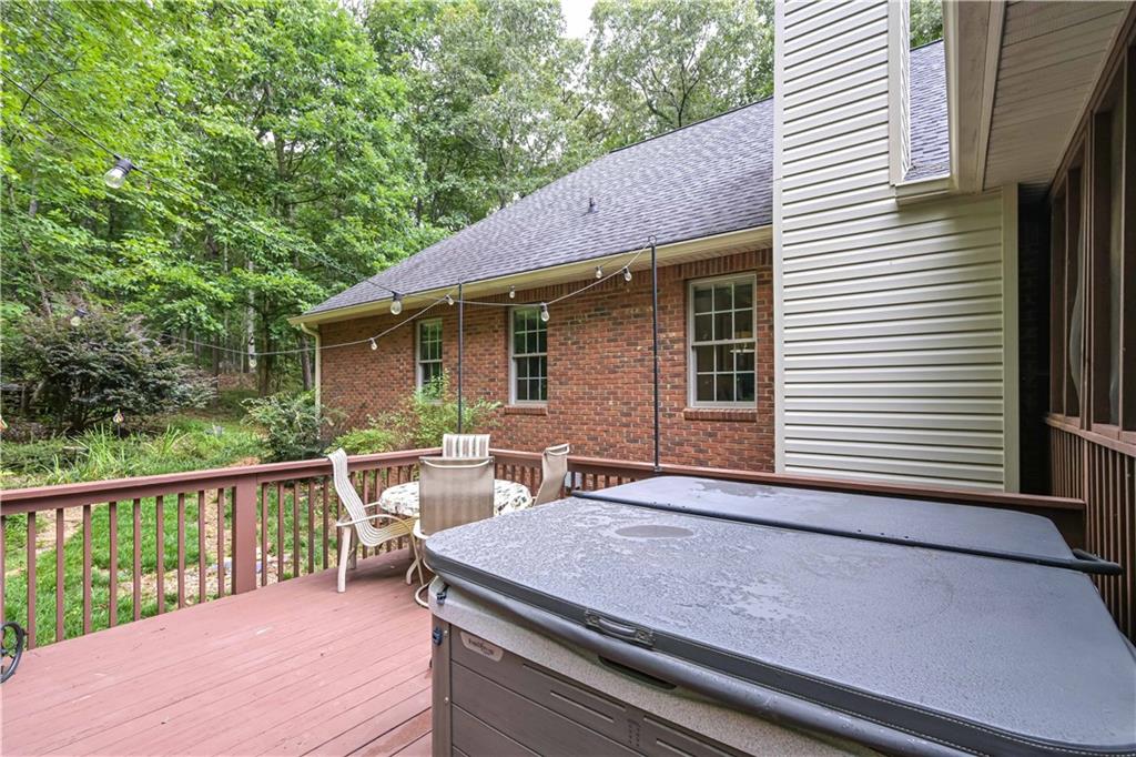 5885 West Chapel Hill Road Douglasville, GA 30135 - Photo 30 of 42 a view of a deck with wooden floor and fence next to a yard