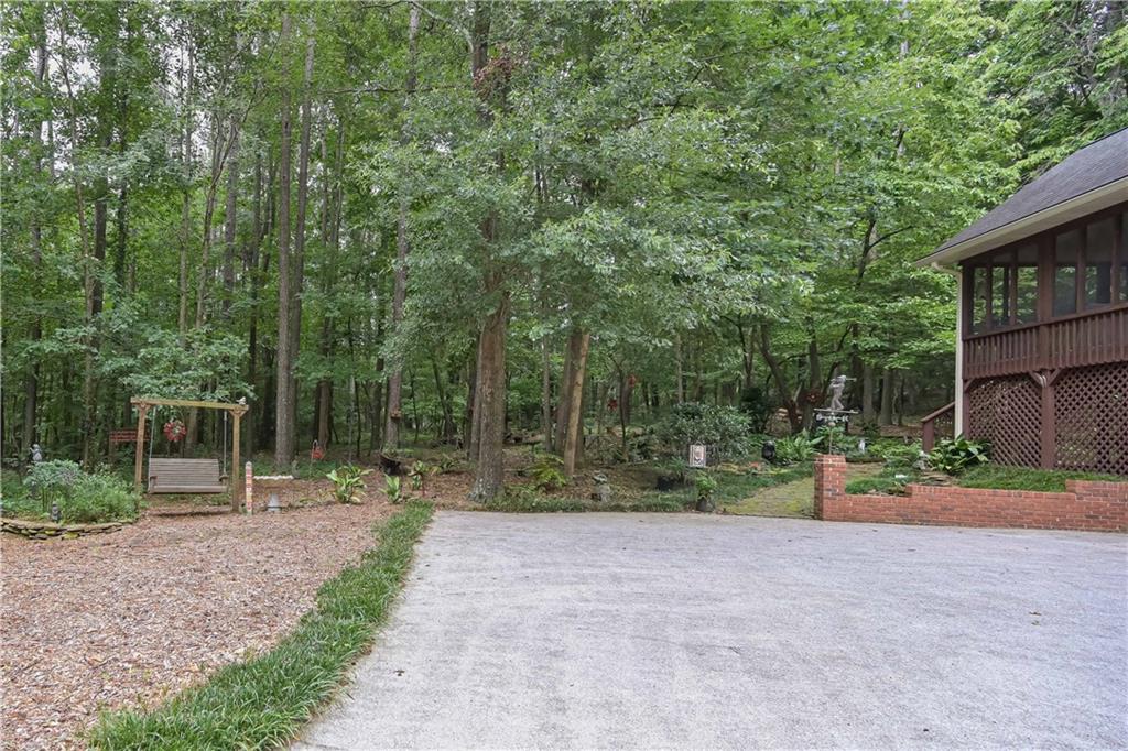 5885 West Chapel Hill Road Douglasville, GA 30135 - Photo 4 of 42 a backyard of a house with lots of green space and fountain