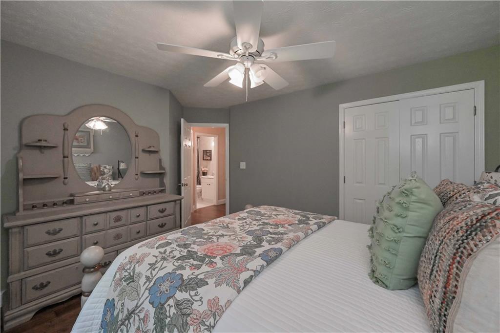 5885 West Chapel Hill Road Douglasville, GA 30135 - Photo 9 of 42 a bedroom with a large bed and a mirror