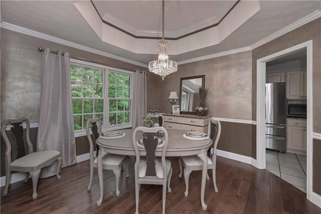 5885 West Chapel Hill Road Douglasville, GA 30135 - Photo 10 of 42 a view of a dining room with furniture window and wooden floor