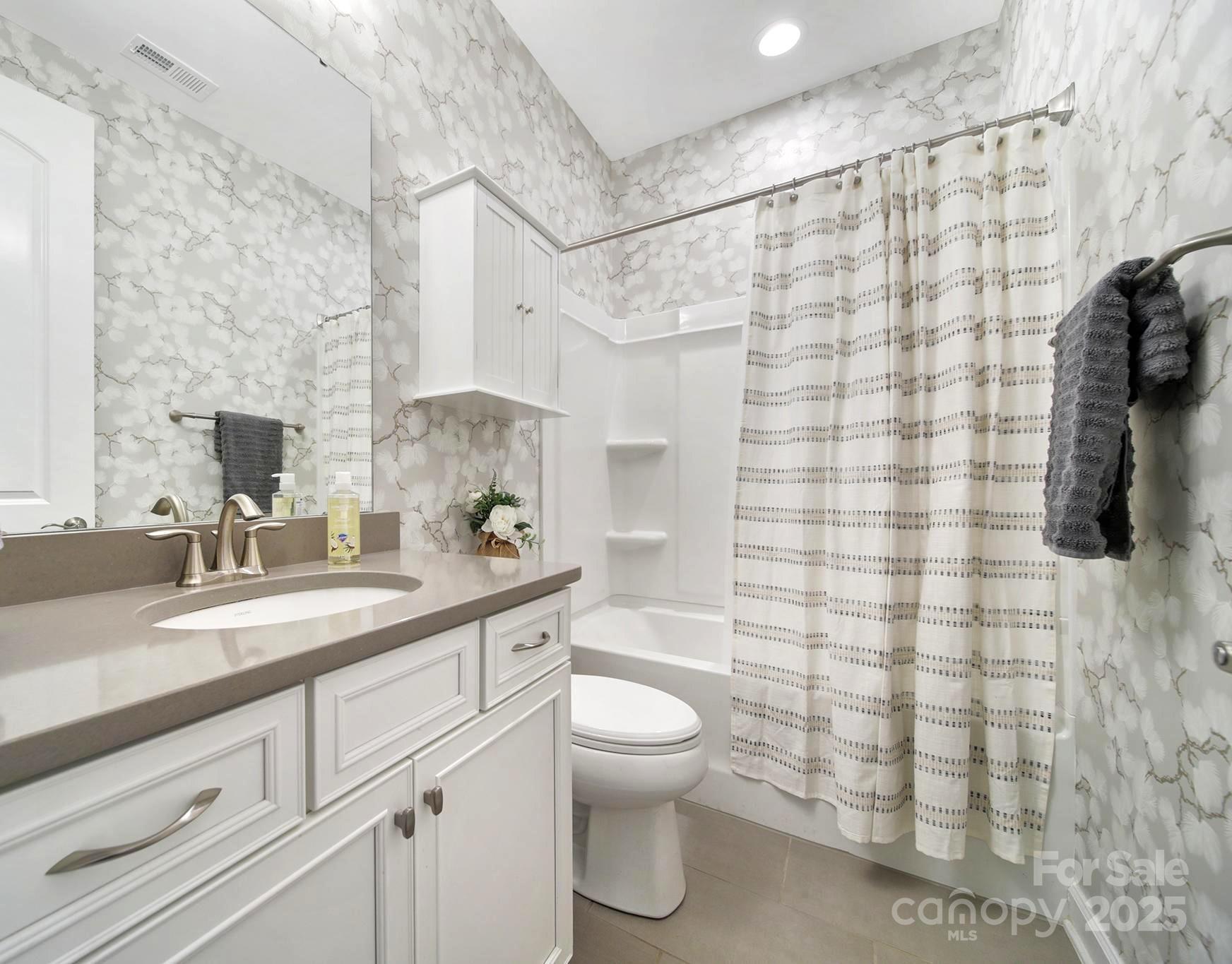 537 Lincoln Quarters Lane Fort Mill, SC 29708 - Photo 22 of 42 a bathroom with a granite countertop sink a toilet and shower