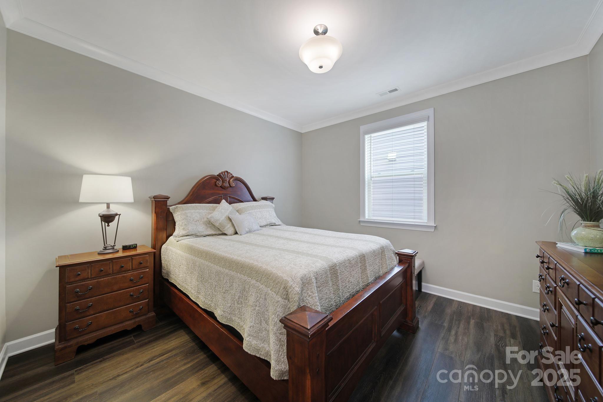 537 Lincoln Quarters Lane Fort Mill, SC 29708 - Photo 23 of 42 a bedroom with a bed and wooden floor