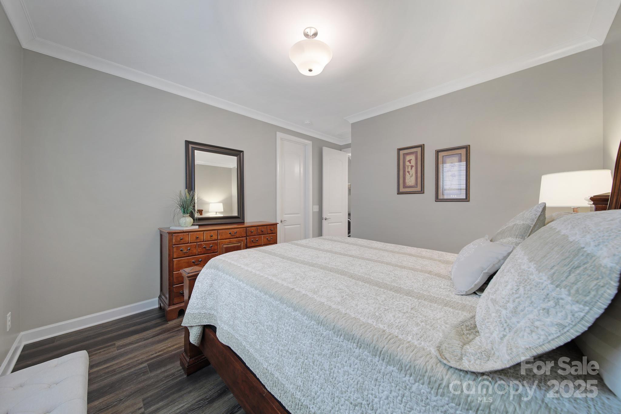 537 Lincoln Quarters Lane Fort Mill, SC 29708 - Photo 24 of 42 a bedroom with a bed and a lamp